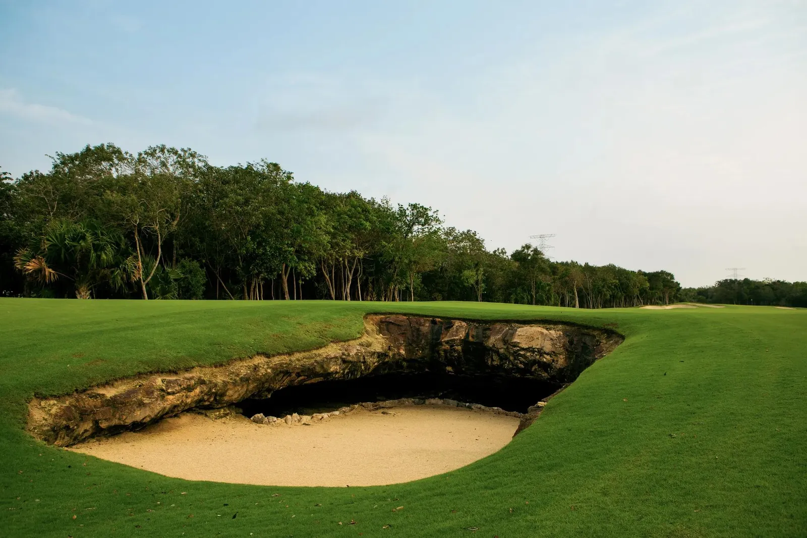 A bunker and fairway at El Camaleón against the jungle