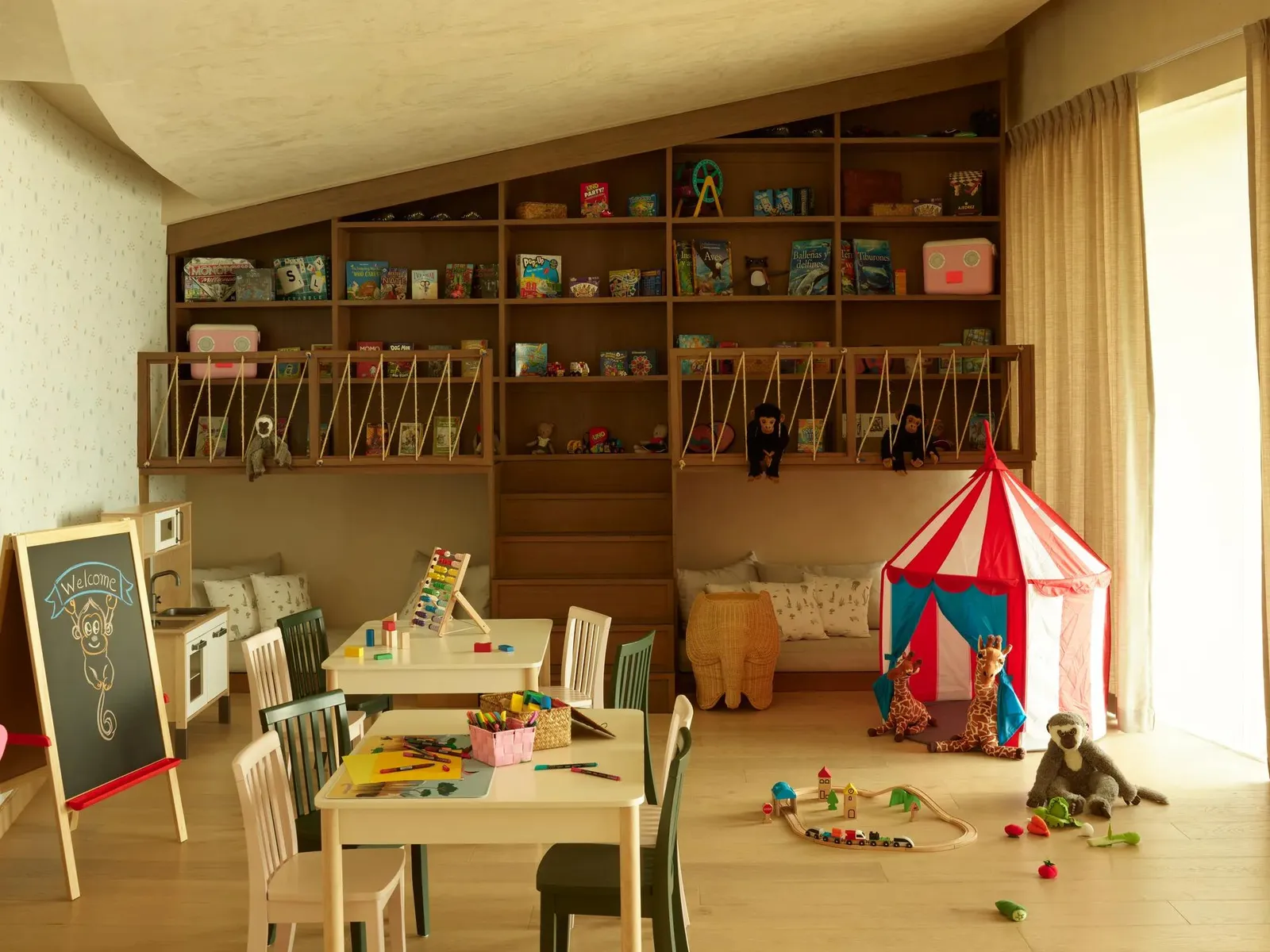 The children’s club, with its small tables and striped tent