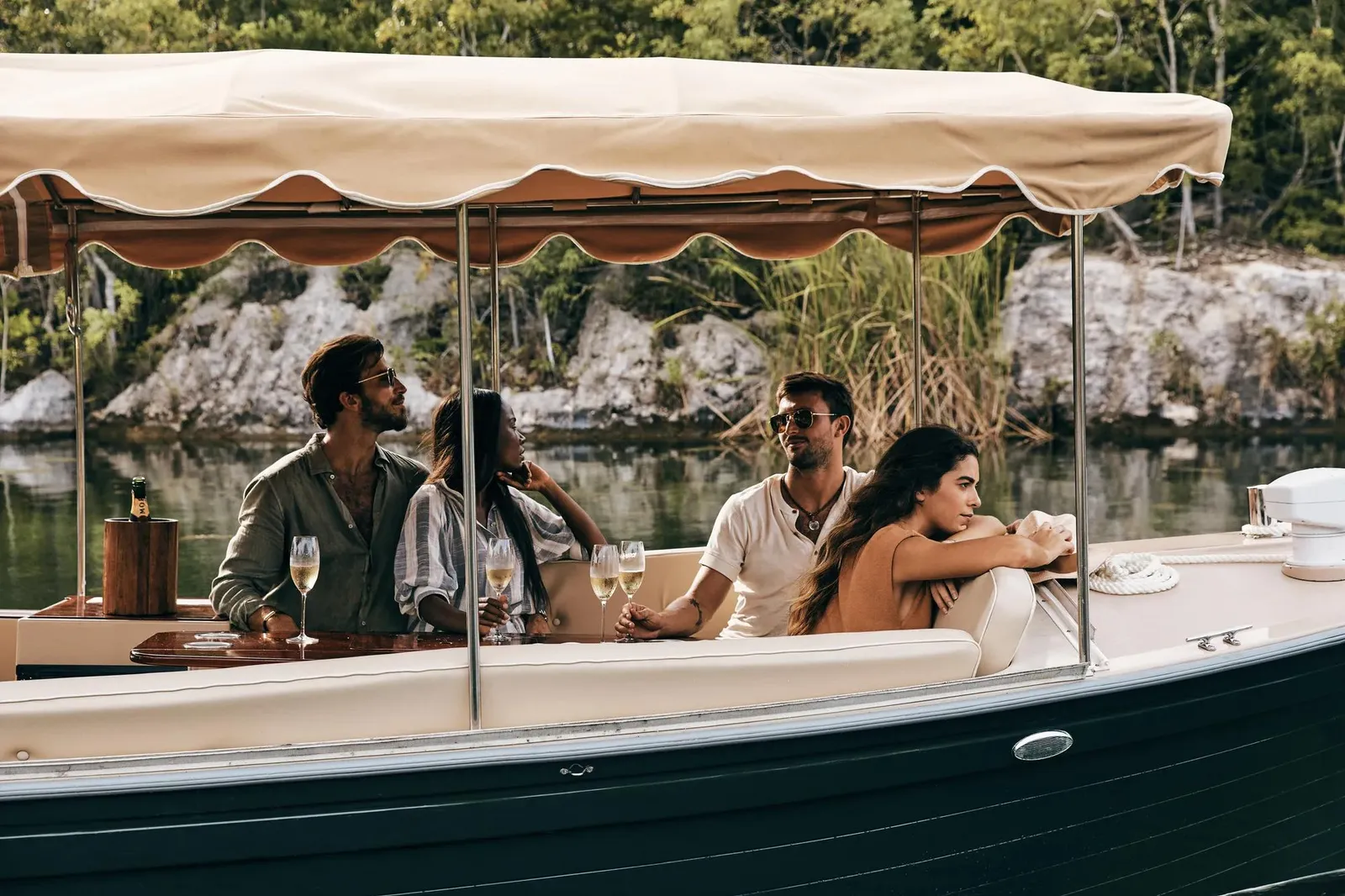 Guests under the awning of a boat on the lagoon