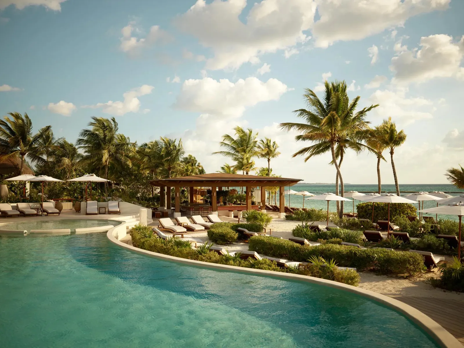 The Punta Bonita pool among palms, the sea beyond