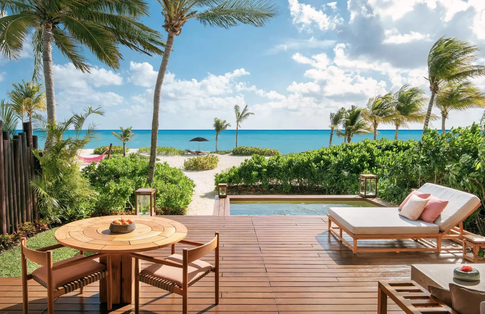The terrace with a lounger and plunge pool, steps from the sand