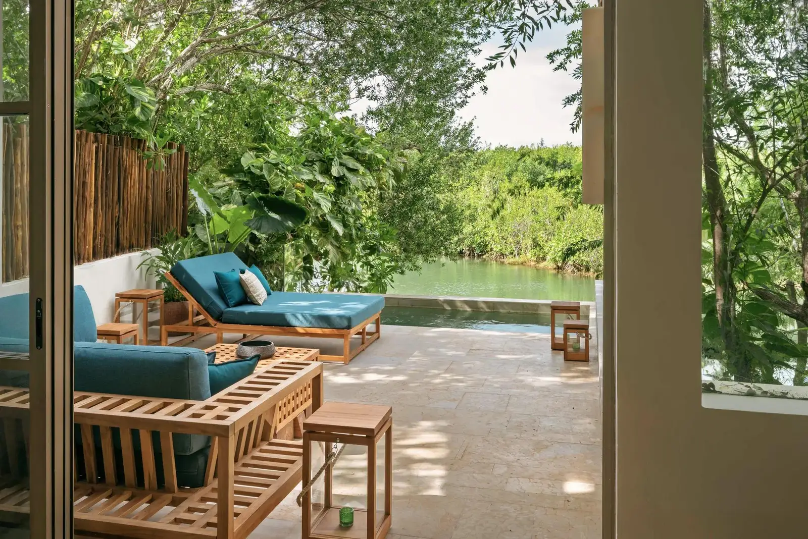 The terrace with a sofa and plunge pool, facing the lagoon