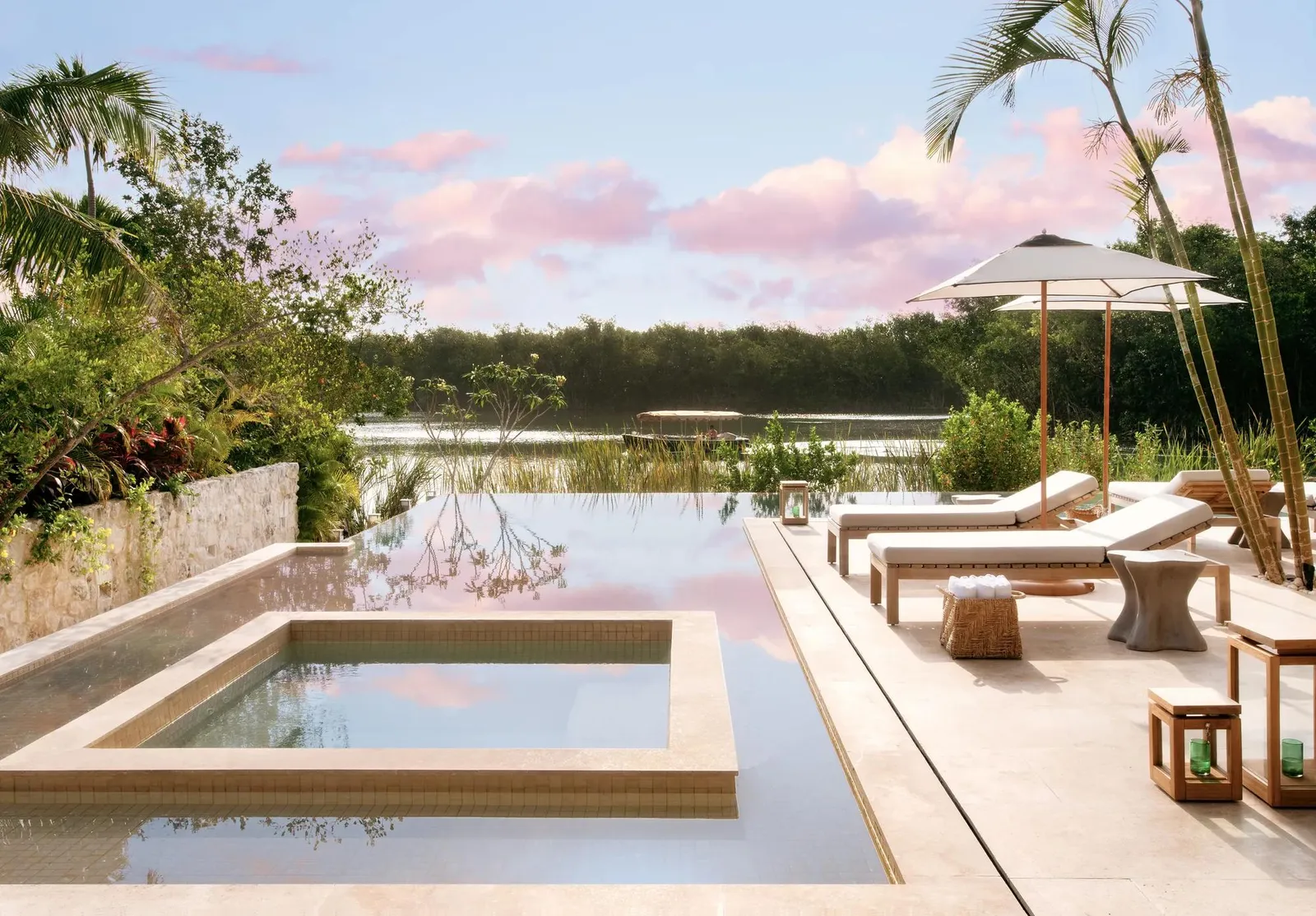 The hot tub and pool above the lagoon at sunset