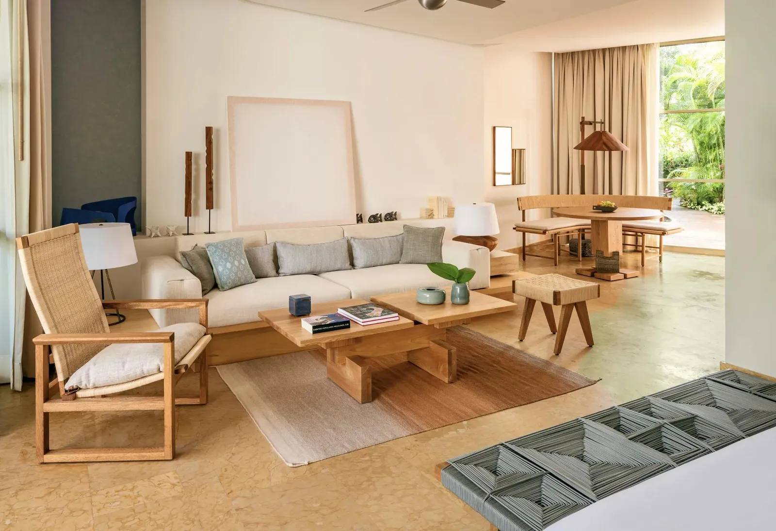 The sitting area with a sofa and pale wooden armchairs
