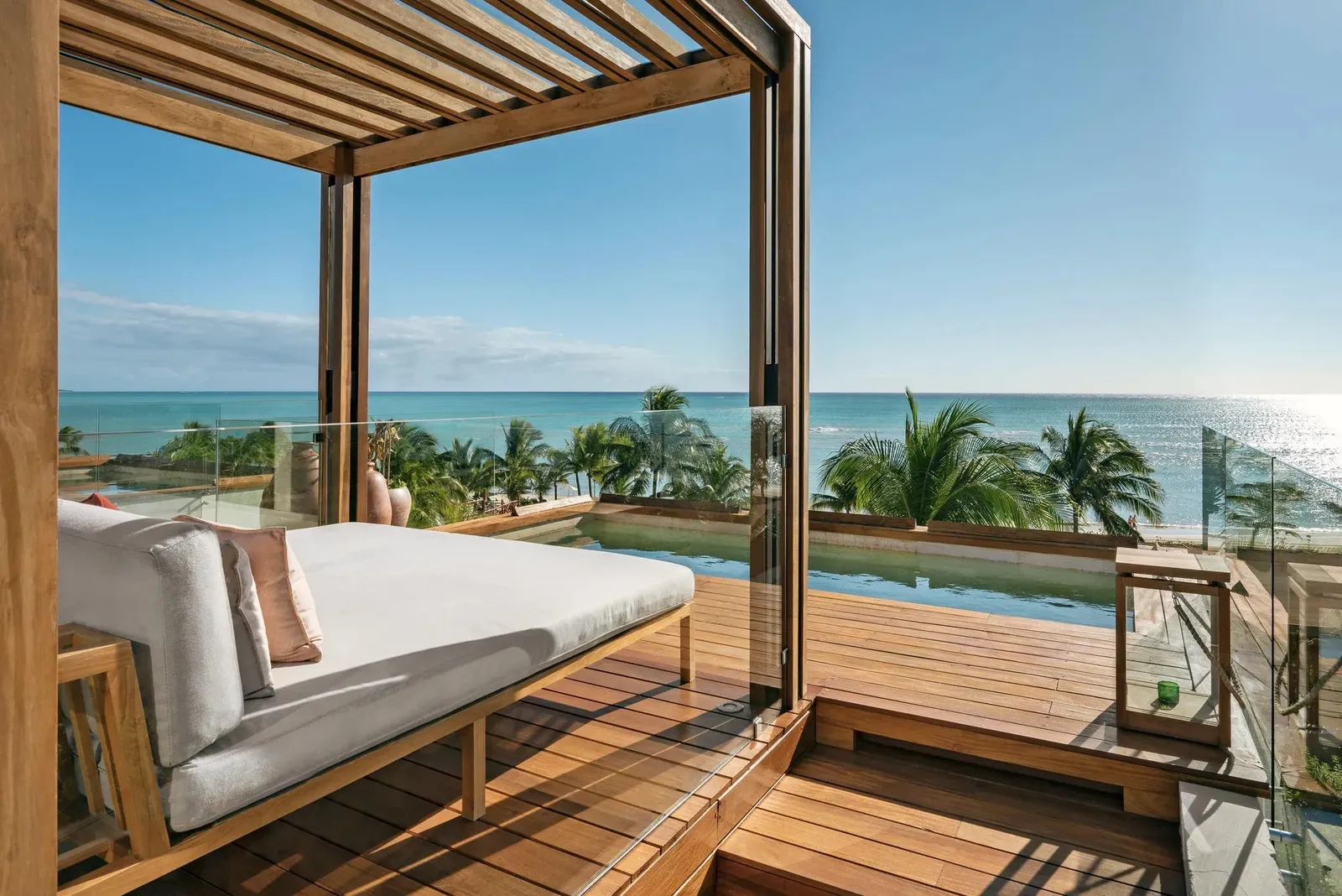 The daybed under the pergola, the sea beyond the railing