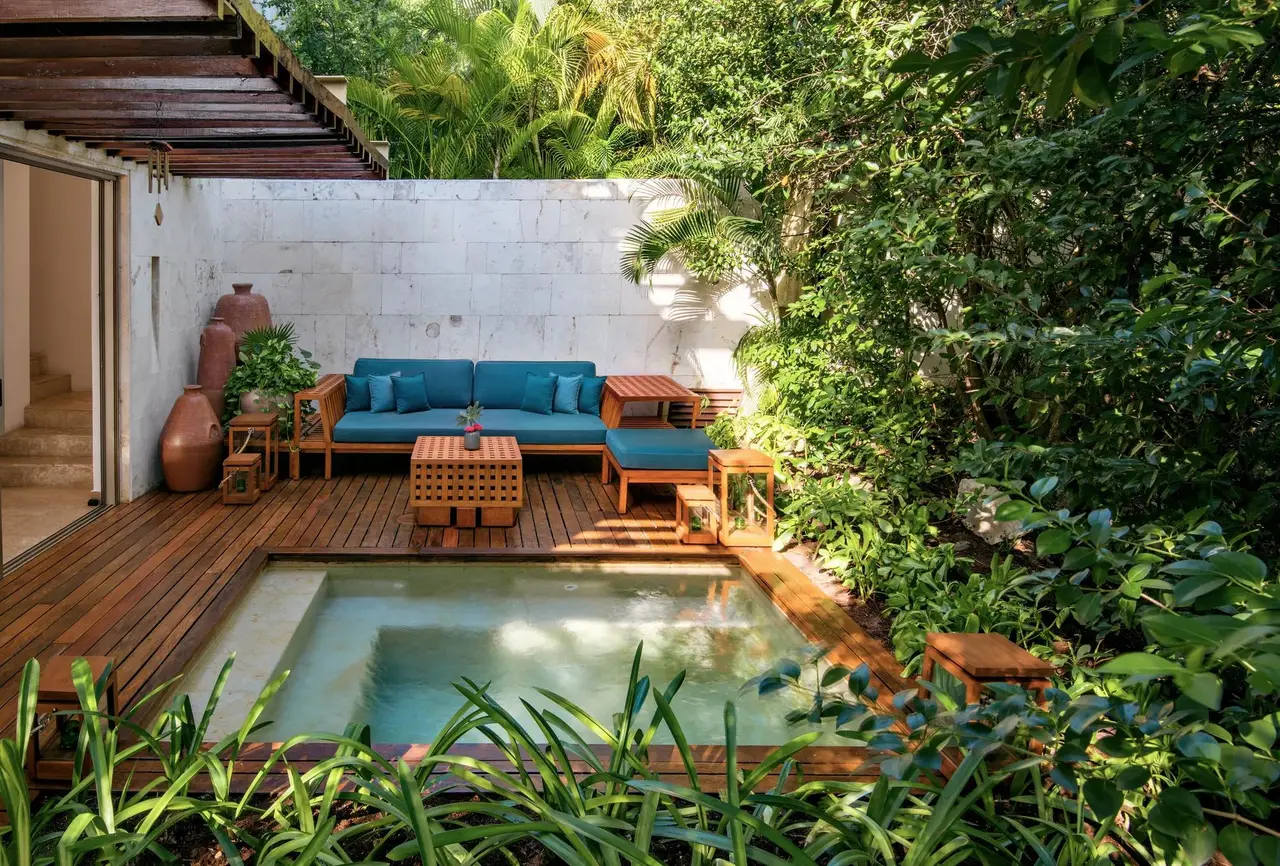 The plunge pool and terrace sofa among the plants
