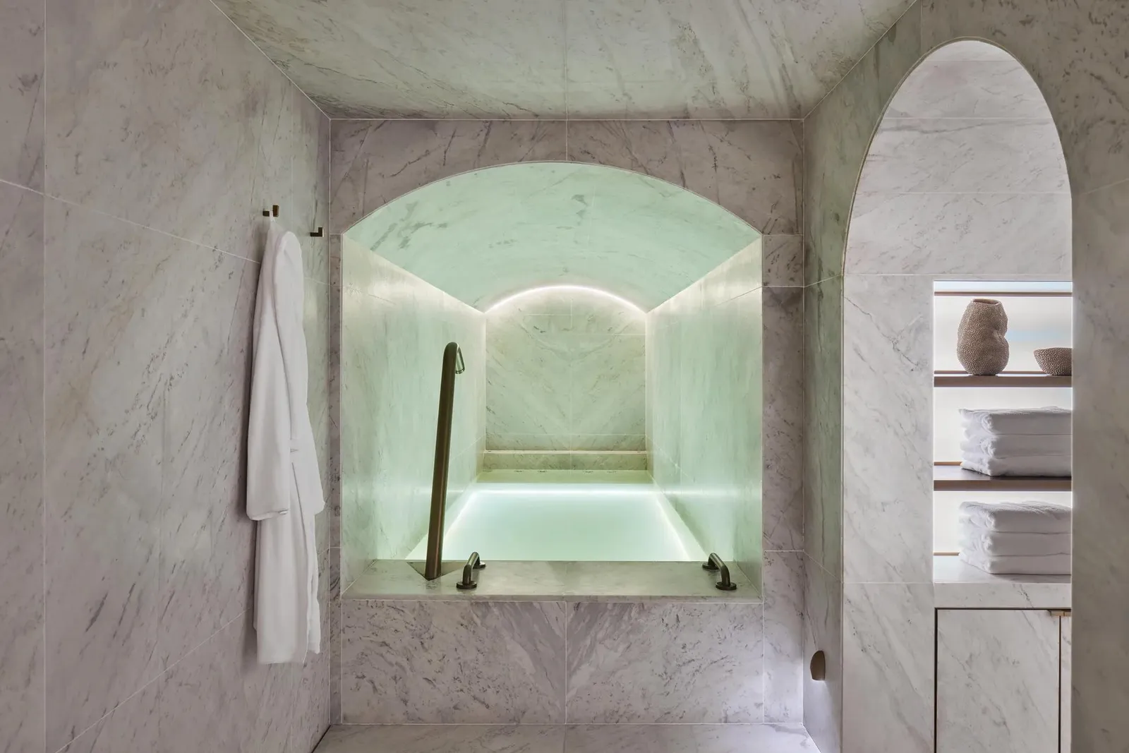 A hydrotherapy bath beneath a pale vaulted ceiling