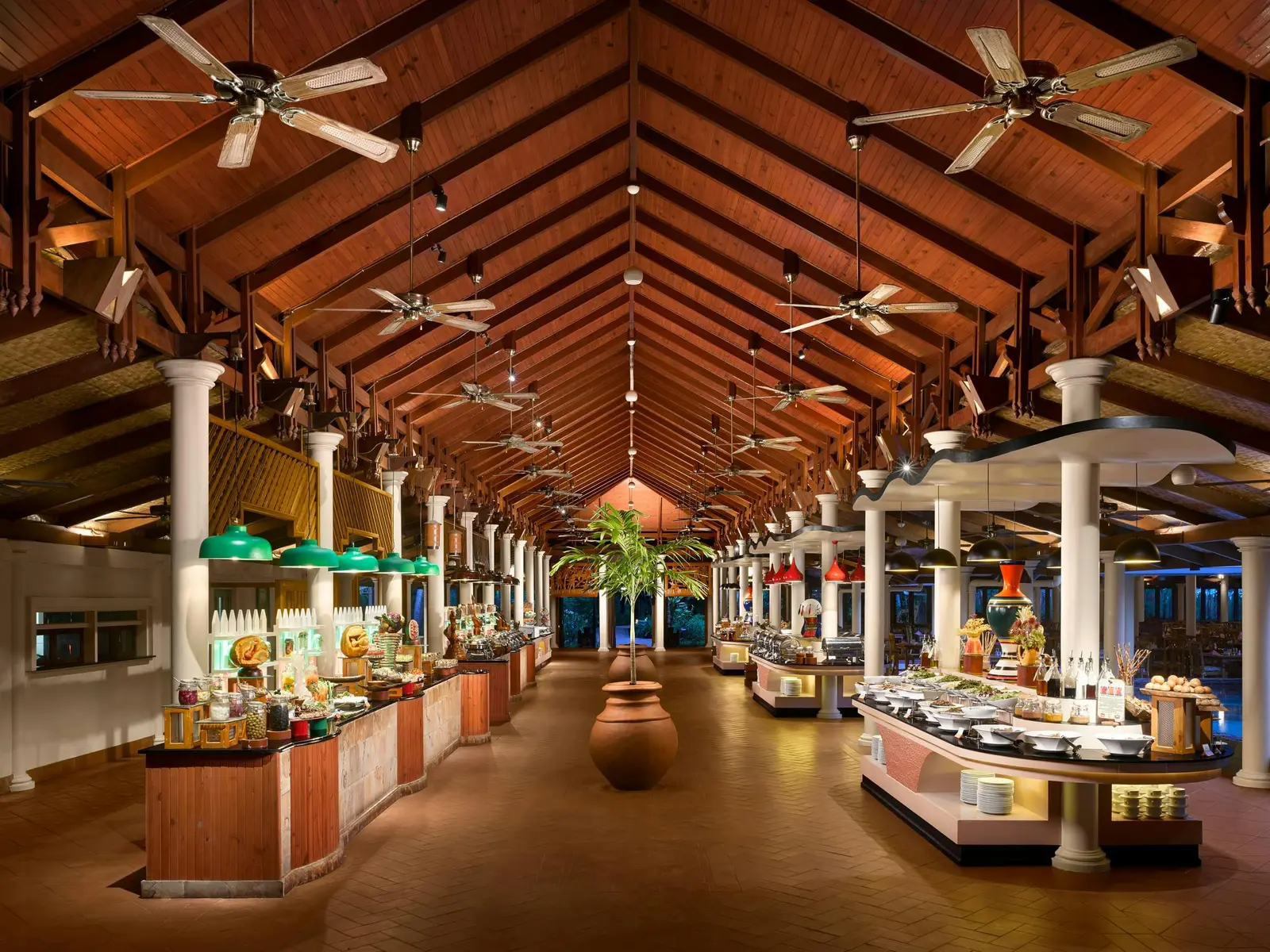 Maakanaa’s dining room under its timber roof, the buffet counters in a row between white columns.