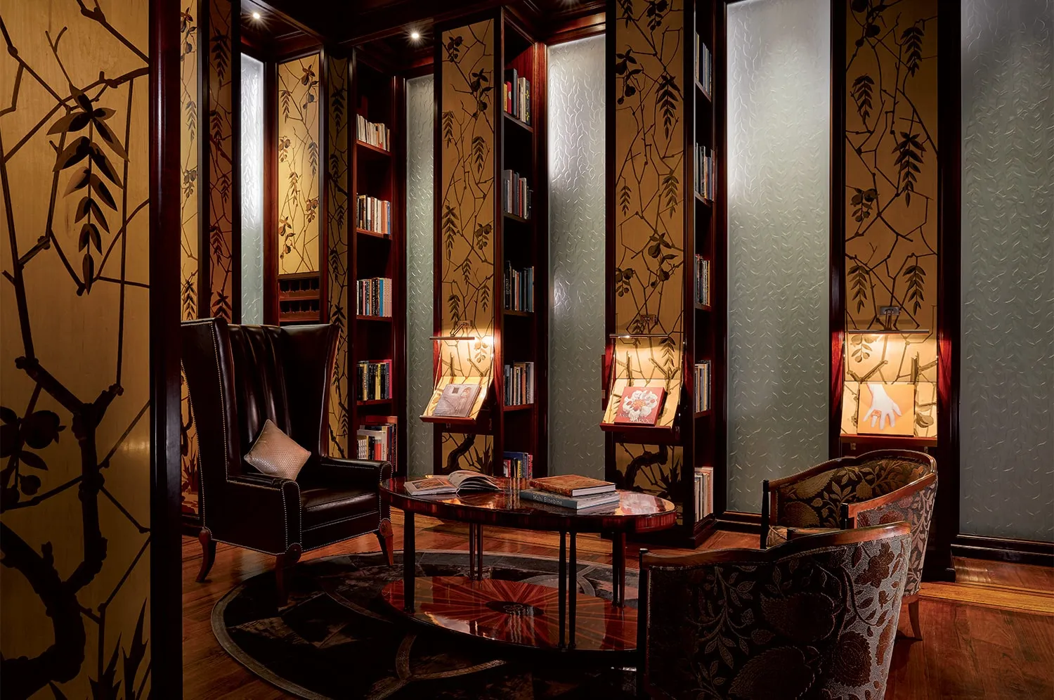 The library with leather armchairs and gilded shelves