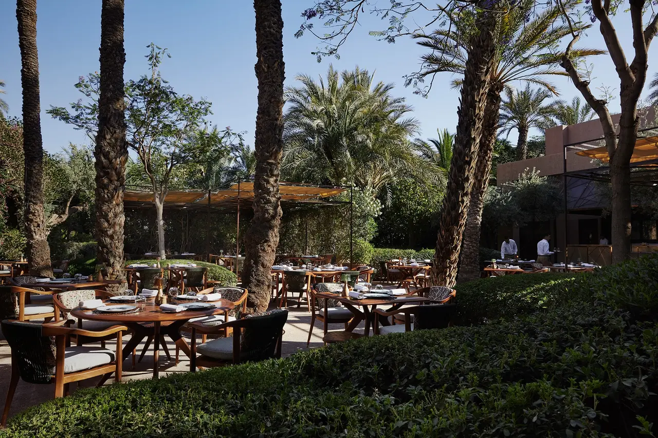Le Jardin’s tables in the shade of the palms