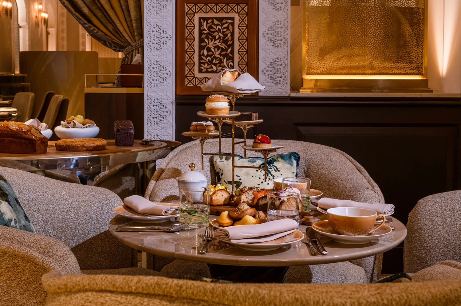 Afternoon tea served on a low table with cakes and pastries