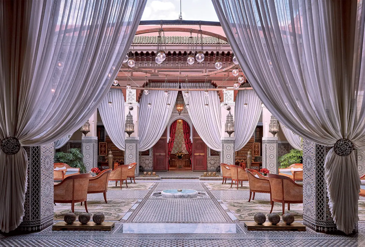A courtyard seen between open drapes