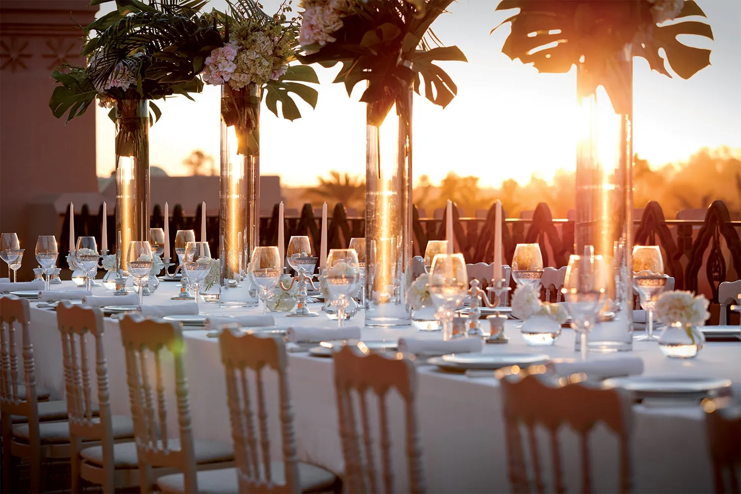 A long table laid in the garden at sunset