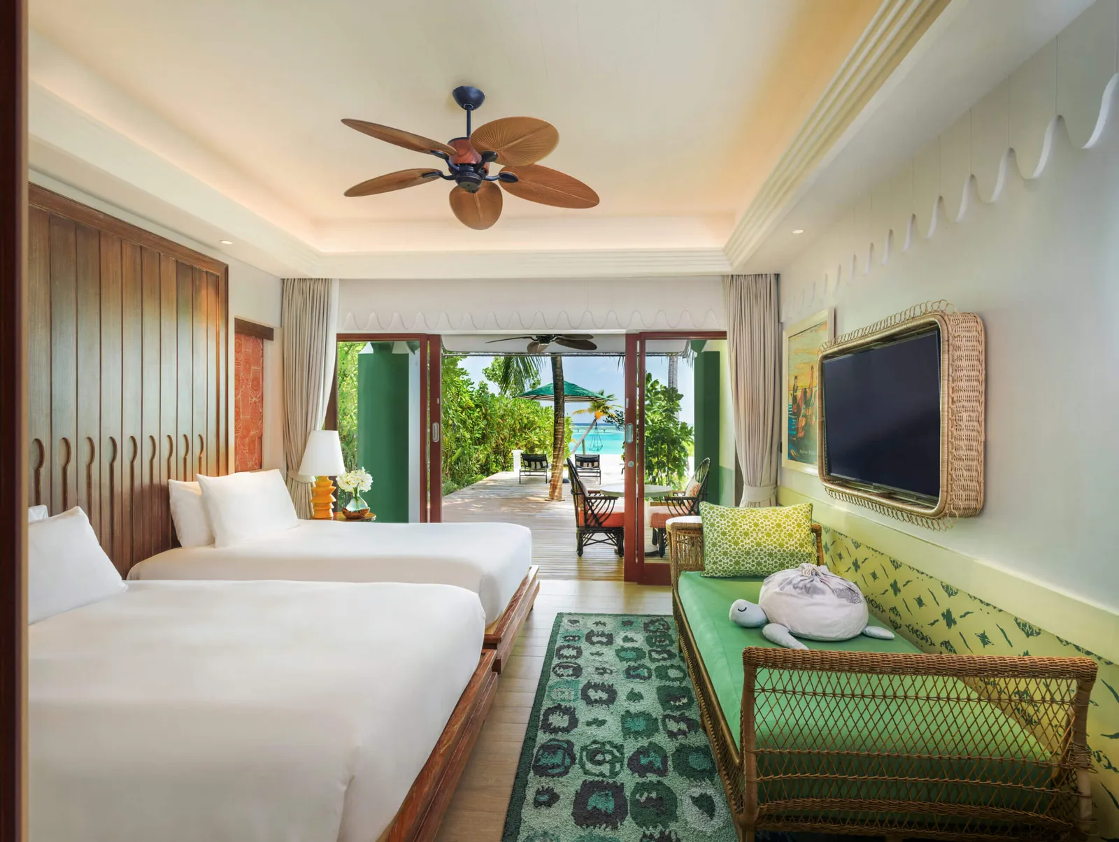 A Beach Room with 2 beds, the green daybed and the door open on to the terrace