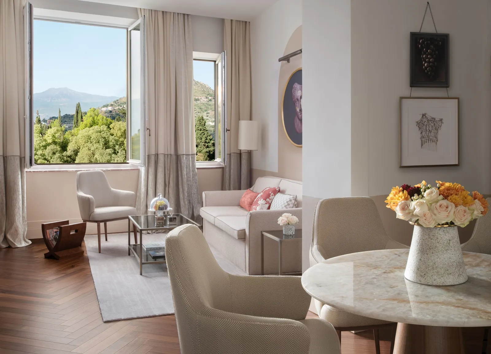 Armchairs, table and windows in the Etna Suite living room