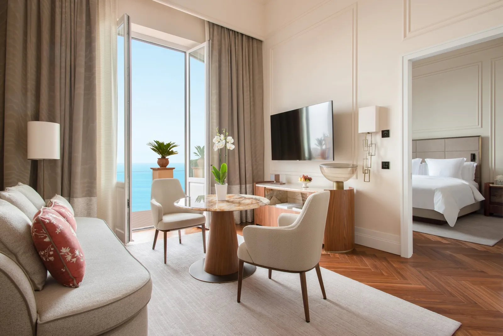Table and sofa outside the bedroom in a Sea-View Executive Suite