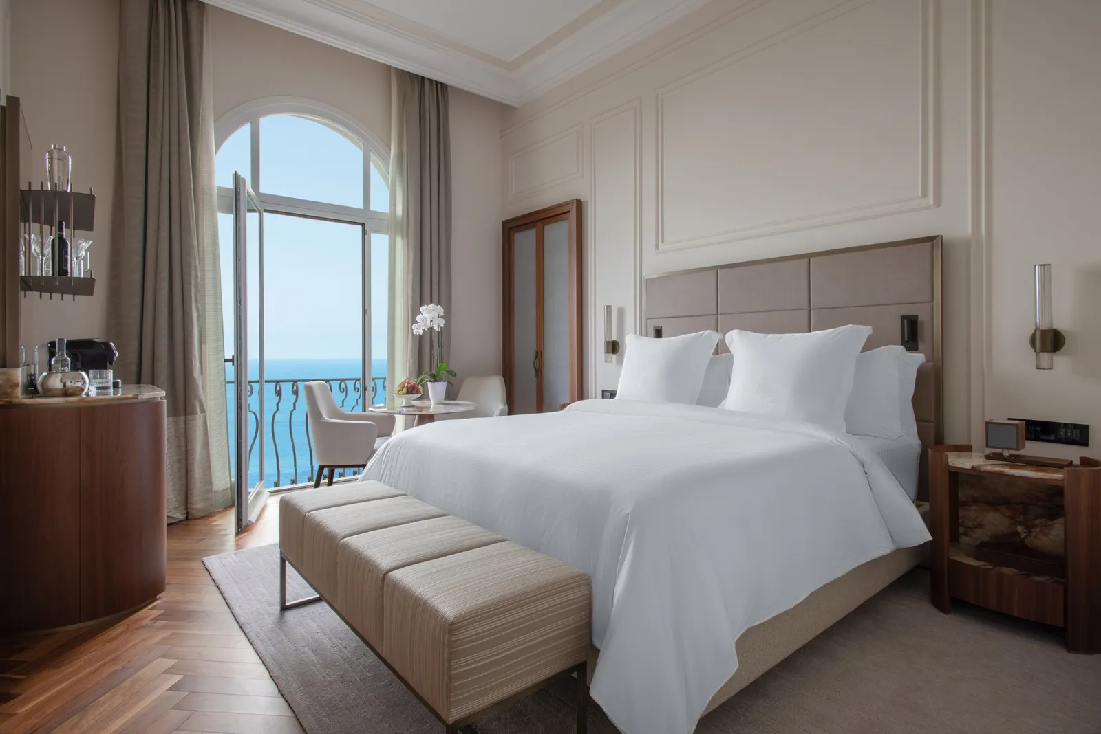 Bed beside the windows in a Sea-View Premium Room