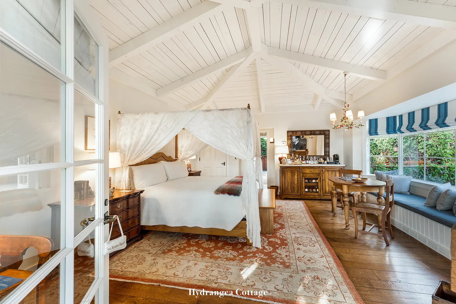 Hydrangea: the all-white bedroom, with its canopy bed, trussed ceiling and a window seat.