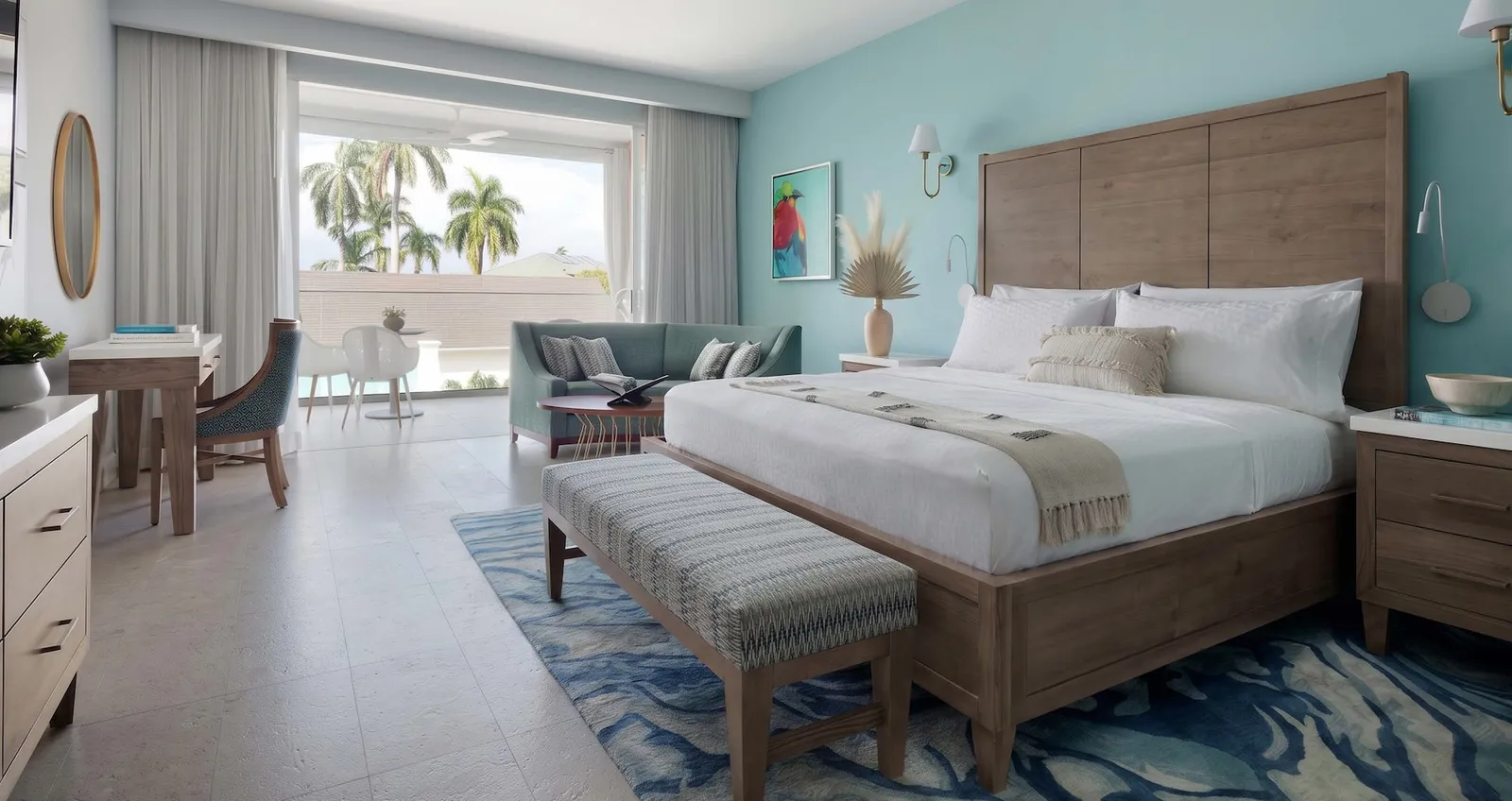 Official image: a bedroom with a slatted timber headboard, a pale blue wall and a balcony over the palms.