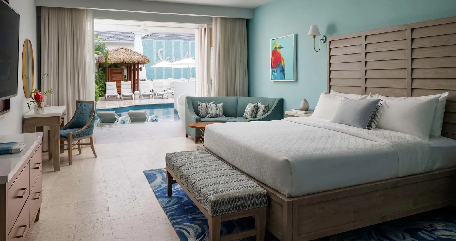 Official image: a ground-floor bedroom open to its patio and the swim-up pool.