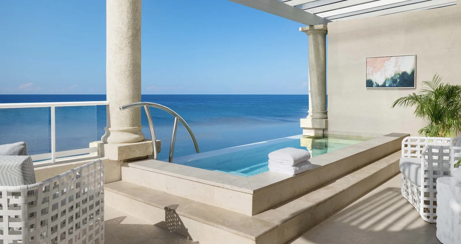 Official image: a terrace with an infinity pool between 2 columns, the sea below.