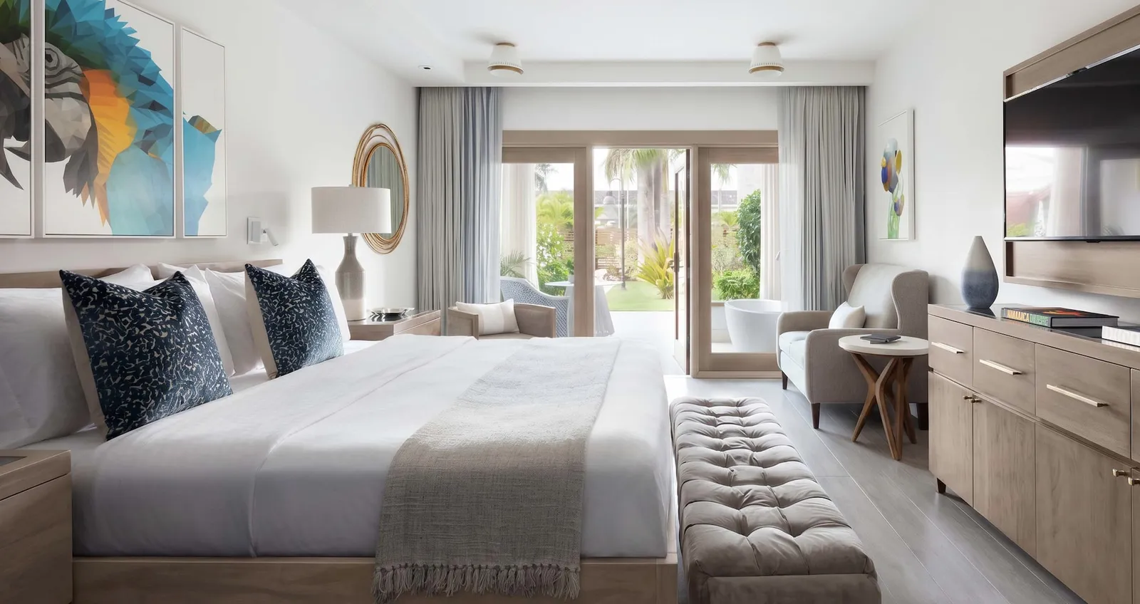 Official image: a ground-floor bedroom with doors open to the patio and the tub outside.