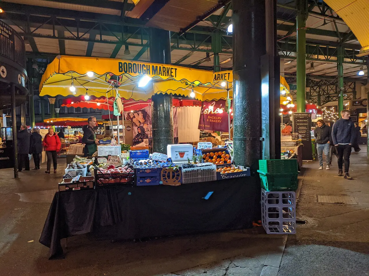 A fruit and vegetable stall under the roofs of Borough Market
