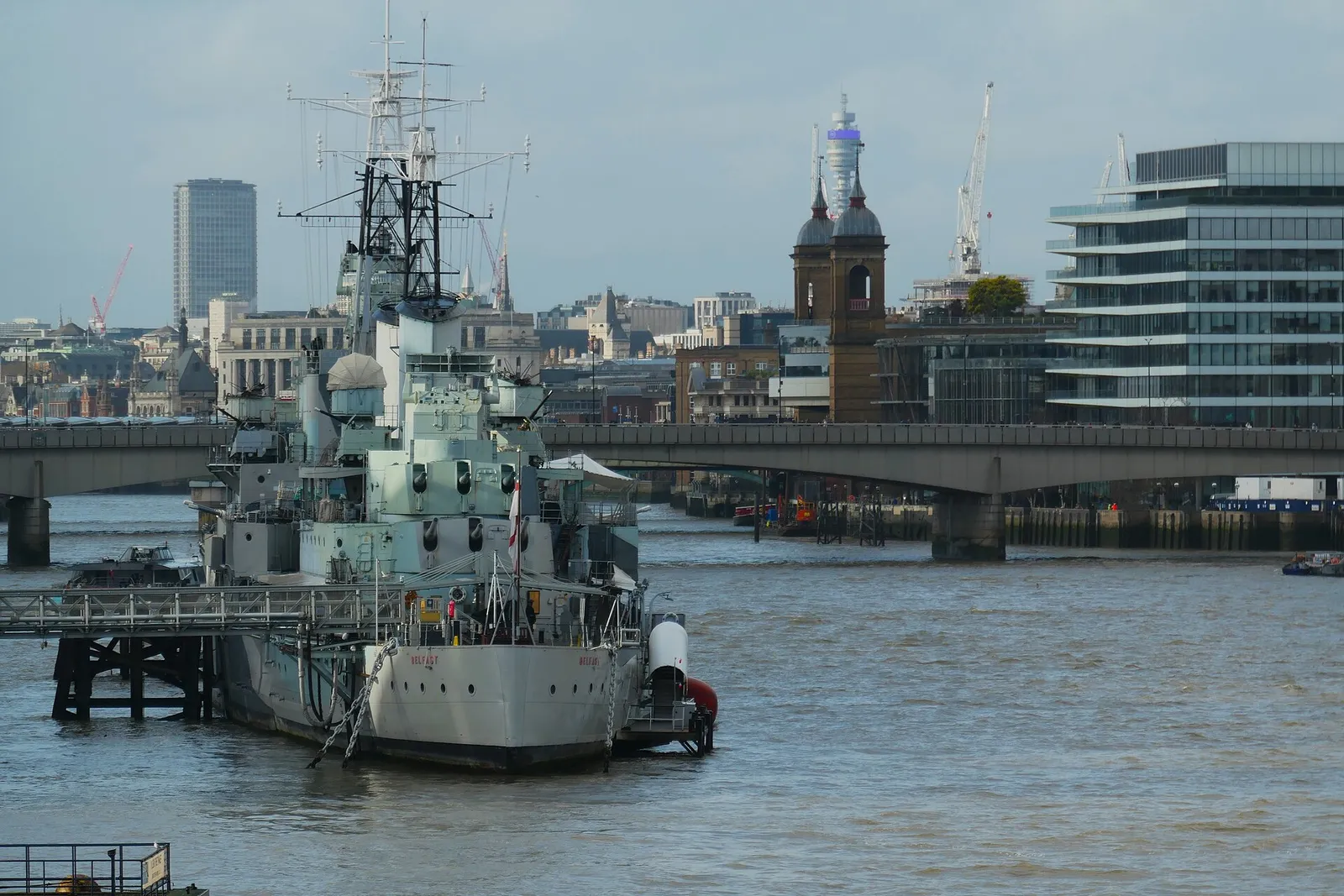 The cruiser HMS Belfast moored on the Thames, with London Bridge behind