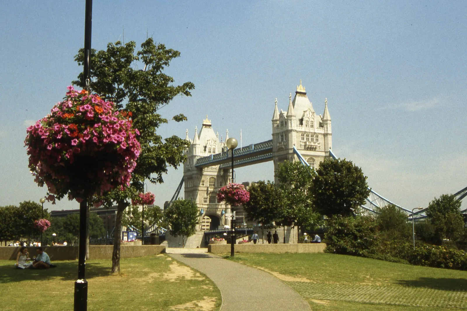 Tower Bridge from the lawn of Potters Fields, with flower baskets