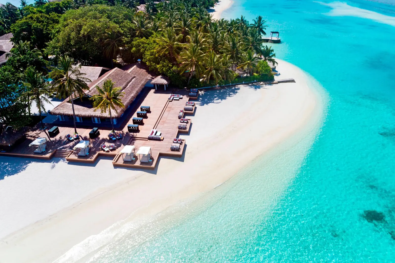 The Anchorage’s deck on the beach from the air, its loungers and the sand spit