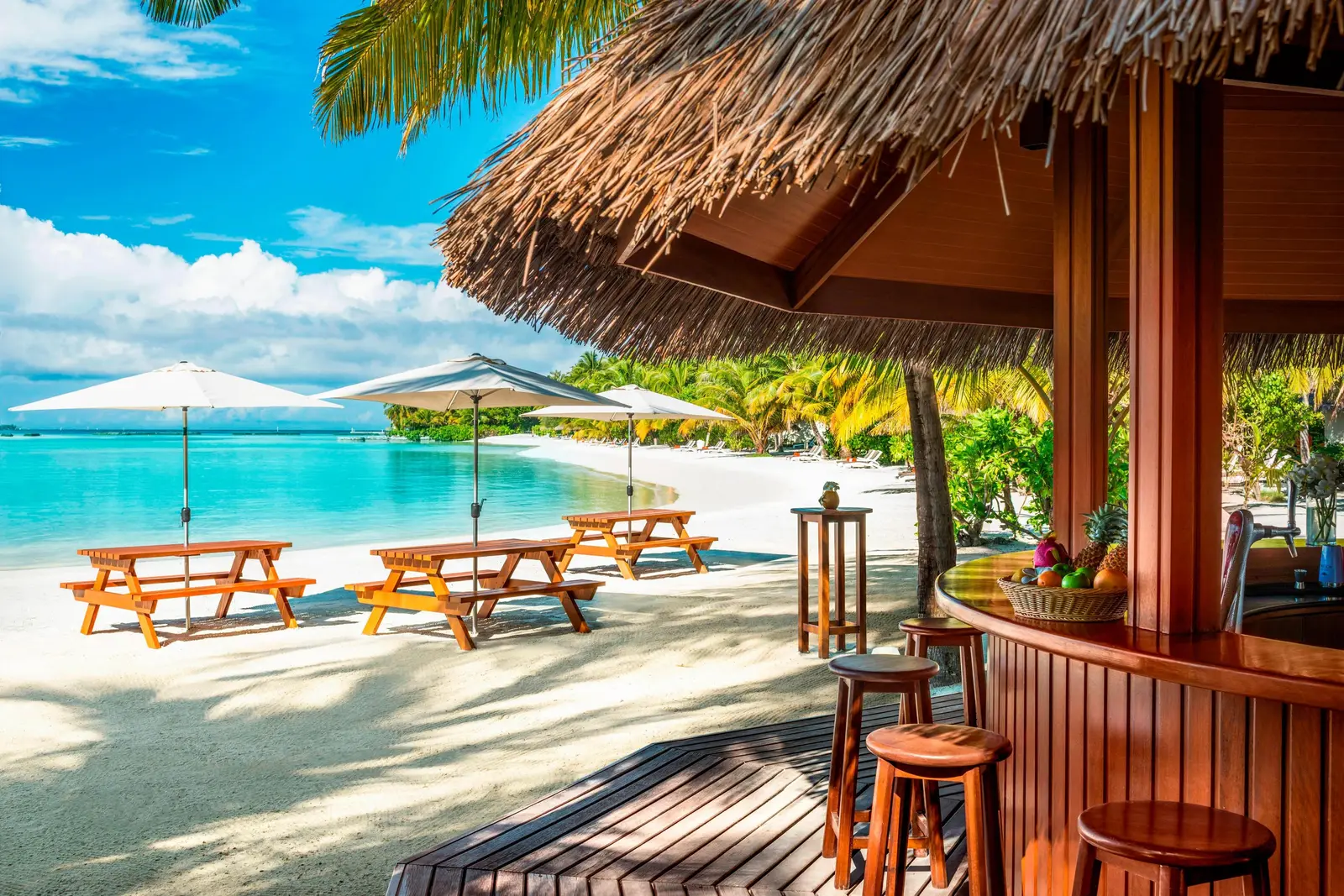The Kakuni Hut’s bar under its thatch, wooden tables on the sand