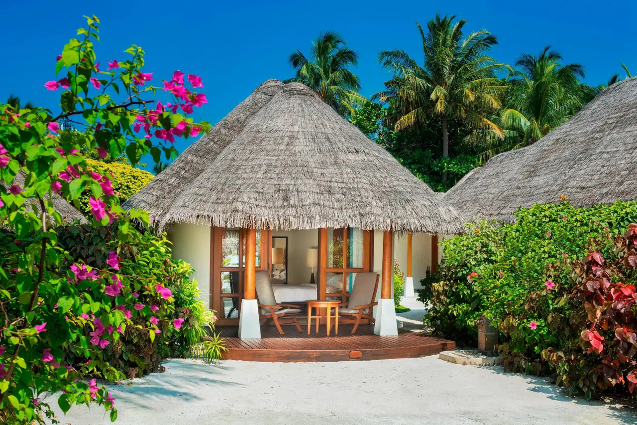 Thatched Island Cottages among bougainvillea and palms