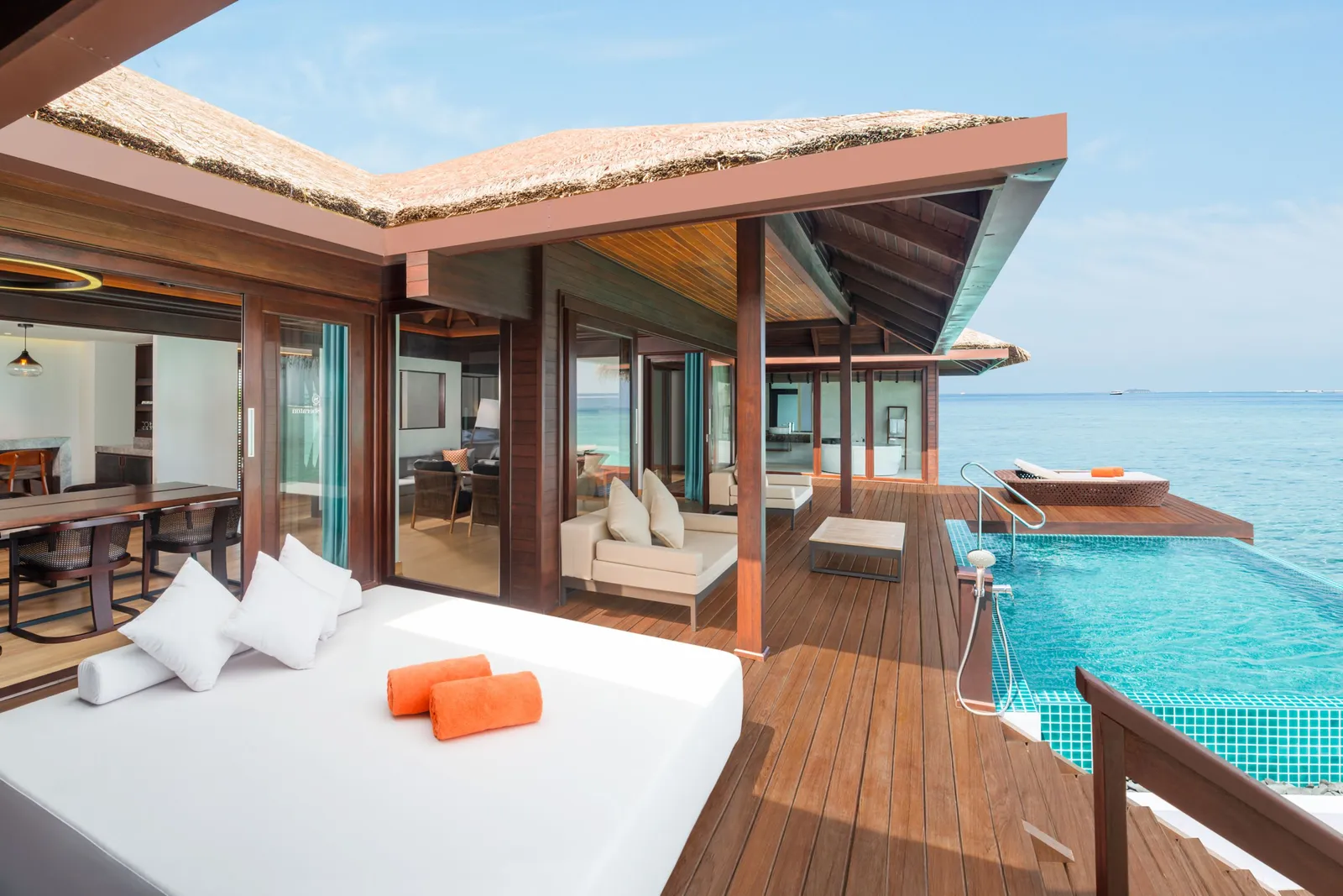 The 2-bedroom villa’s deck over the water, the daybed and the pool
