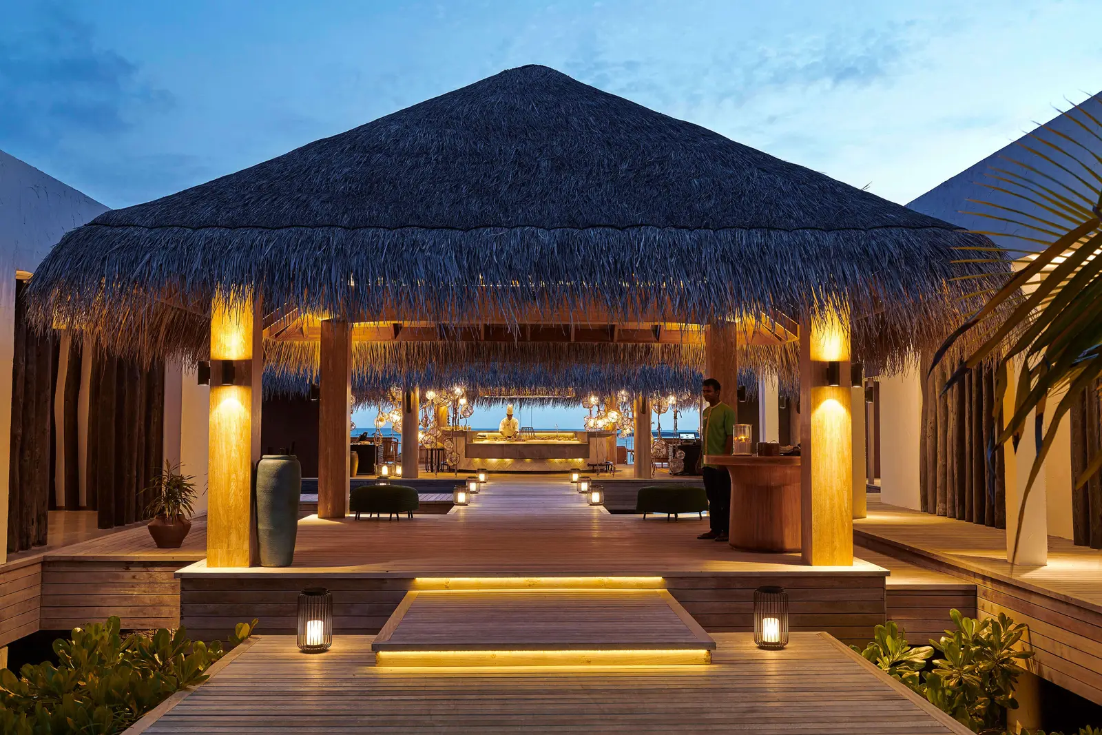 The entrance to Azure in the evening, under its great thatched roof, with the lanterns lit.