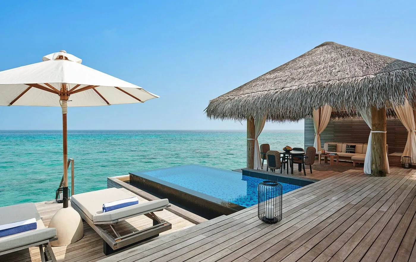 A Two Bedroom Sunrise Water Villa: the pool on the deck and the thatched pavilion over the lagoon.