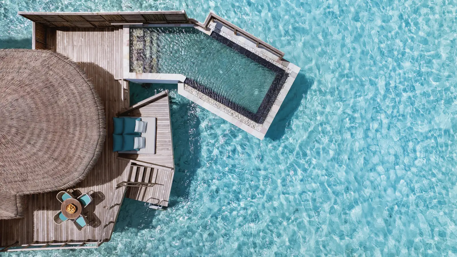 A Water Villa with Pool from above: the round roof, the deck and the pool over the lagoon