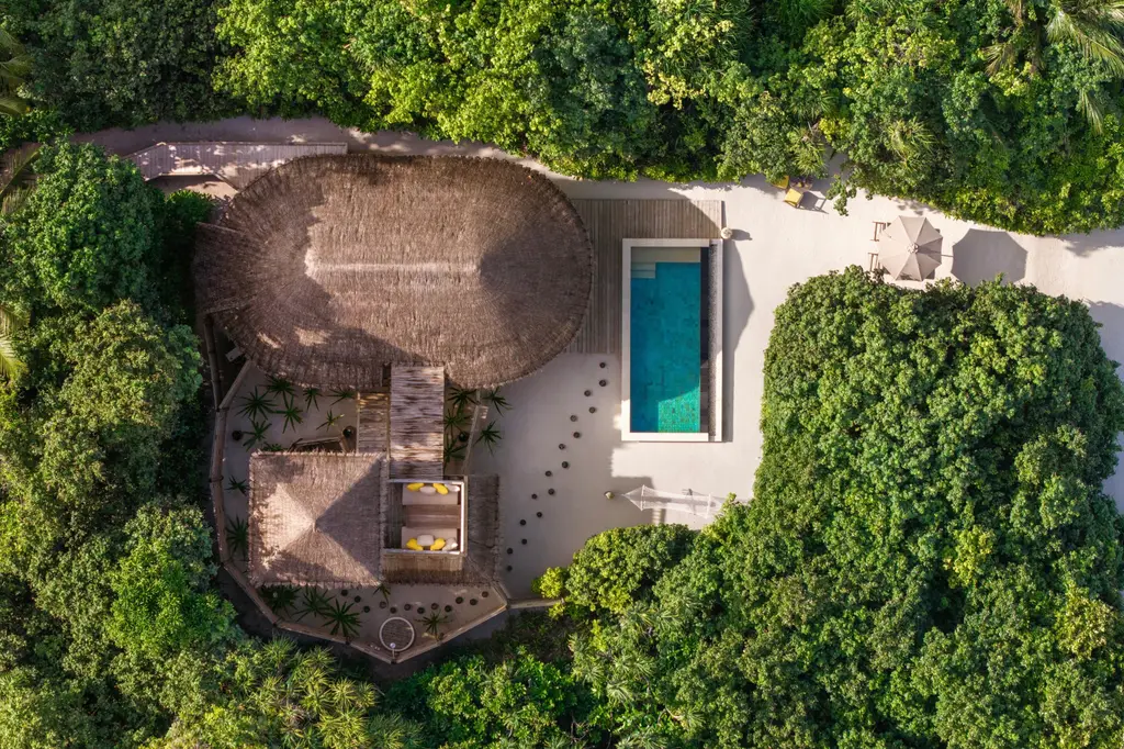An Ocean Beach Villa with Pool from above, in the greenery by the beach