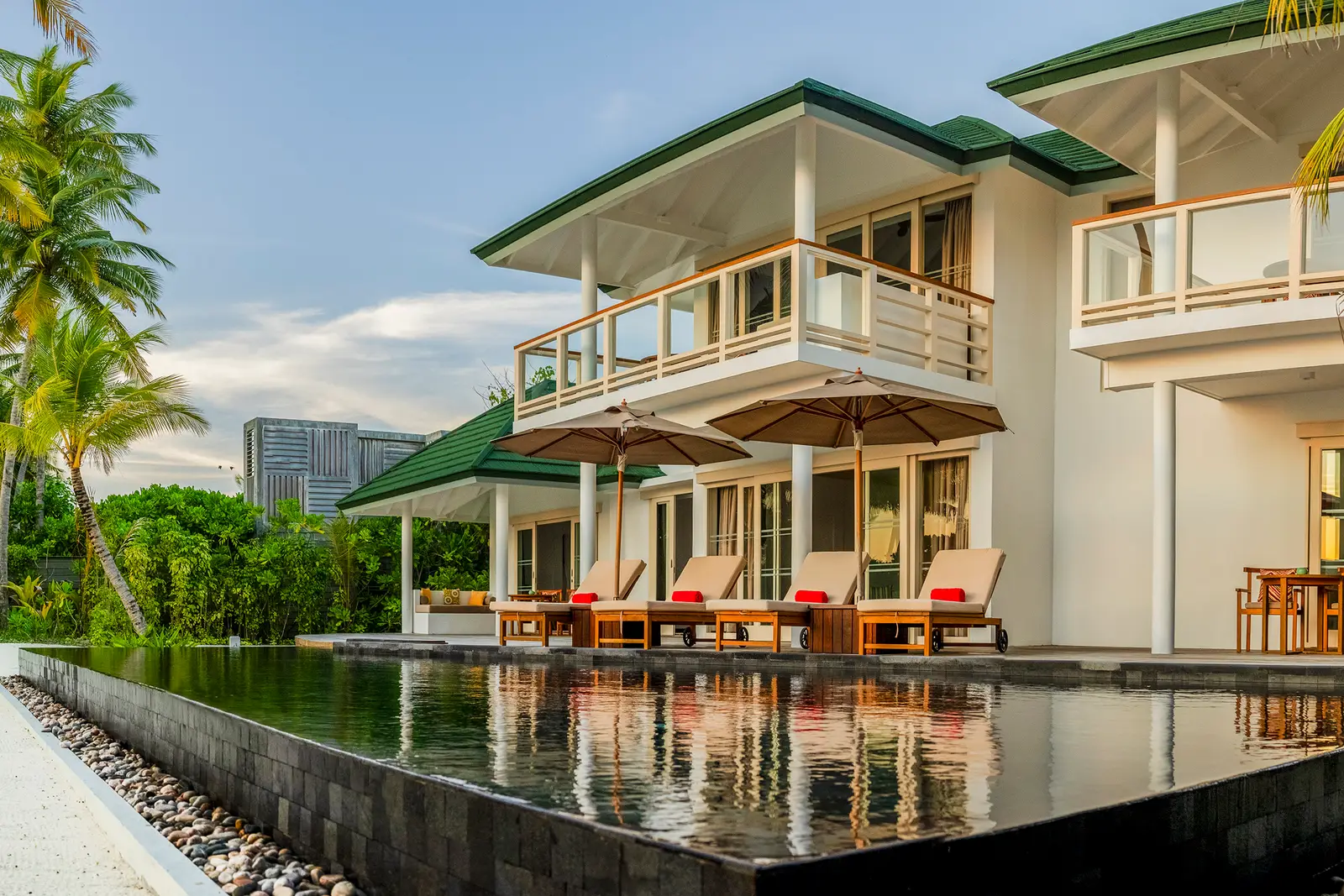 The 2-storey Four Bedroom Beach Residence, its infinity pool in front