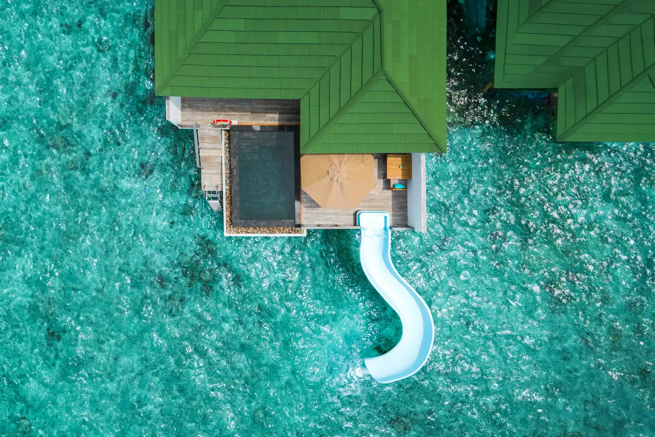 A Lagoon Villa from above, its deck pool and the slide down into the lagoon