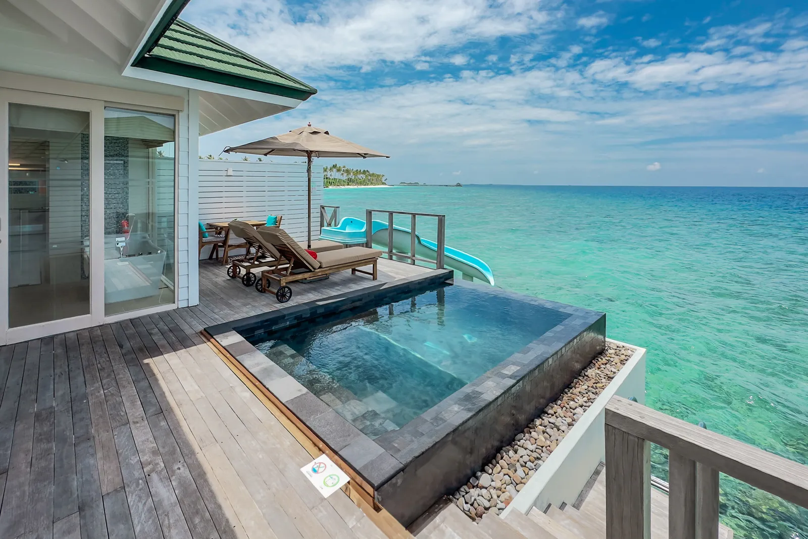 An Ocean Villa’s deck, its pool and loungers facing the open sea
