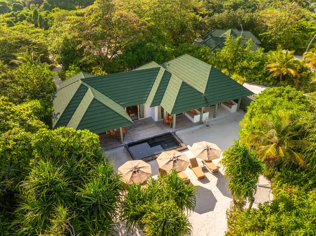 The Three Bedroom Pool Beach Villa from above, green roofs among the trees