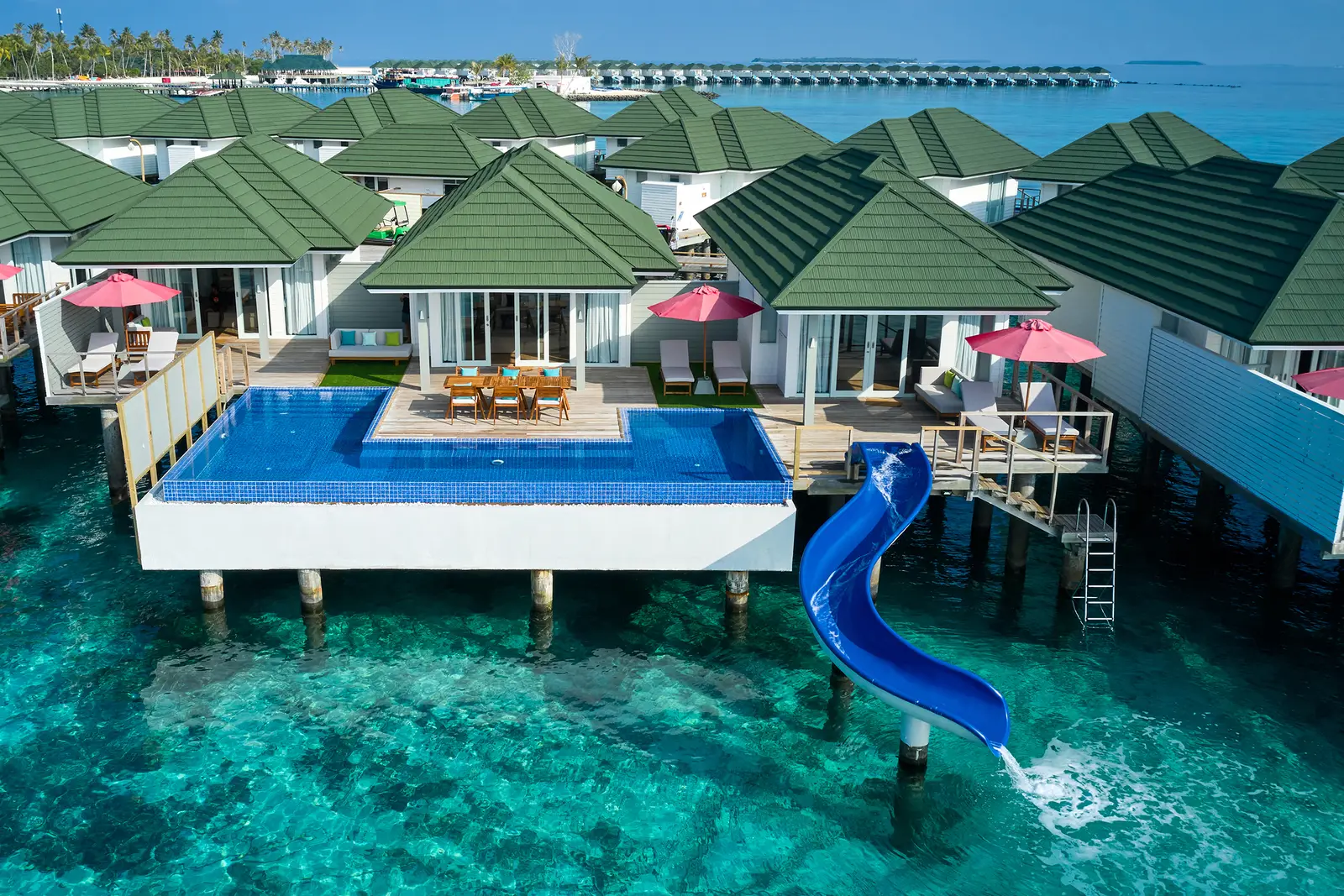 The 3-bedroom overwater villas, the long pool and the blue slide