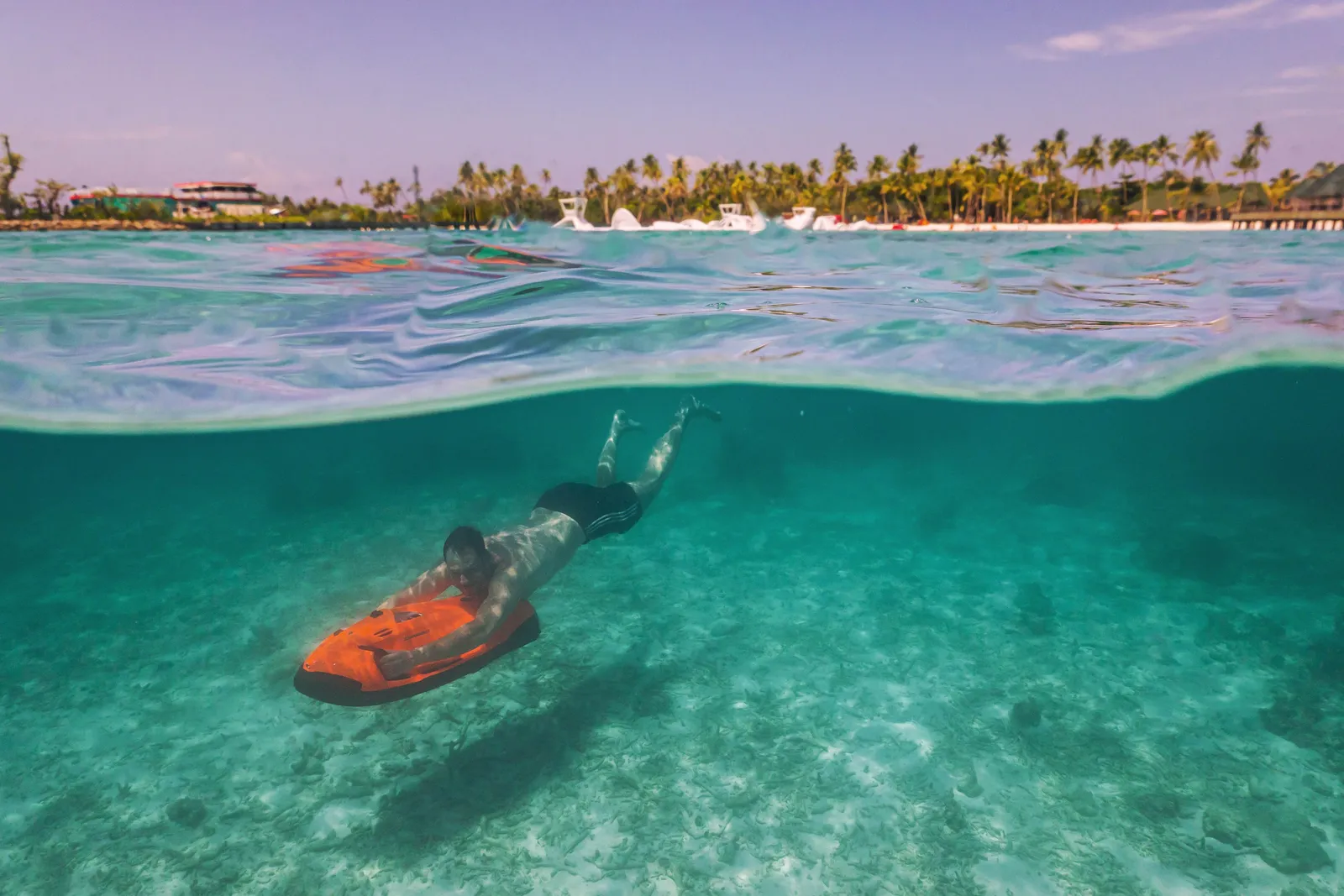 A swimmer with a seabob underwater in the lagoon
