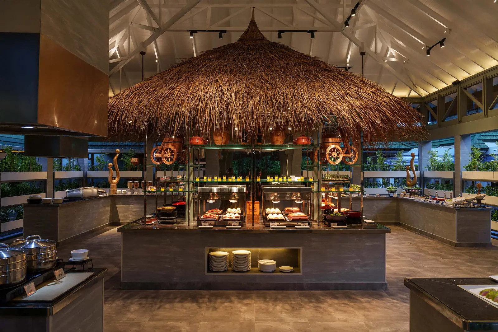 Tempo’s buffet beneath the thatched roof, the open kitchens behind