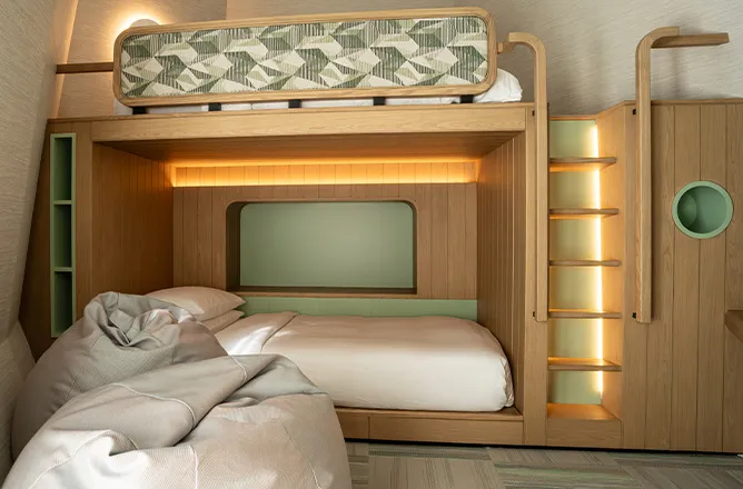 Timber bunk beds in the children’s capsule, with a ladder.