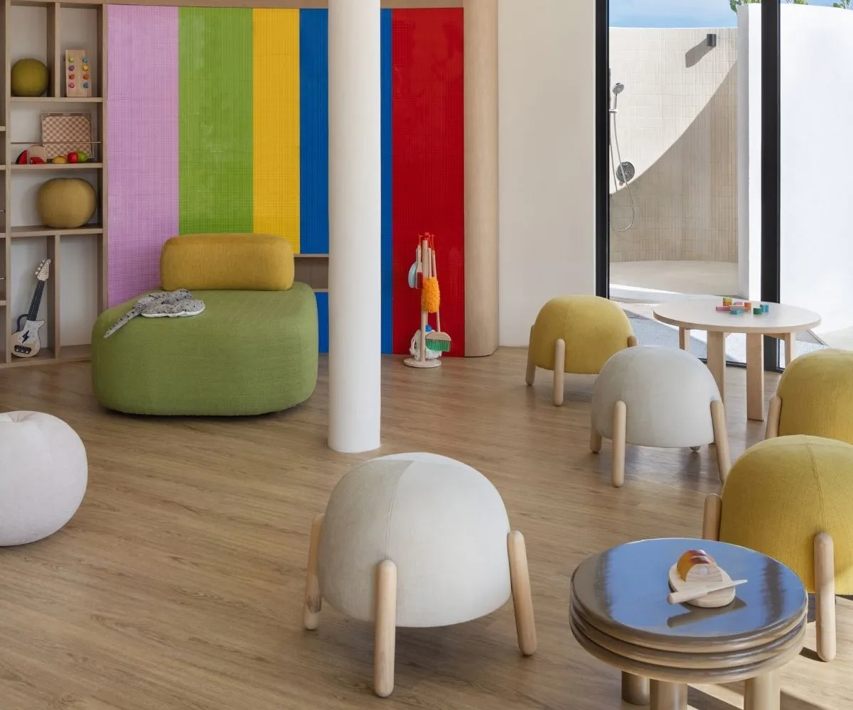 Coloured seating, toy instruments and games in The Nest room.