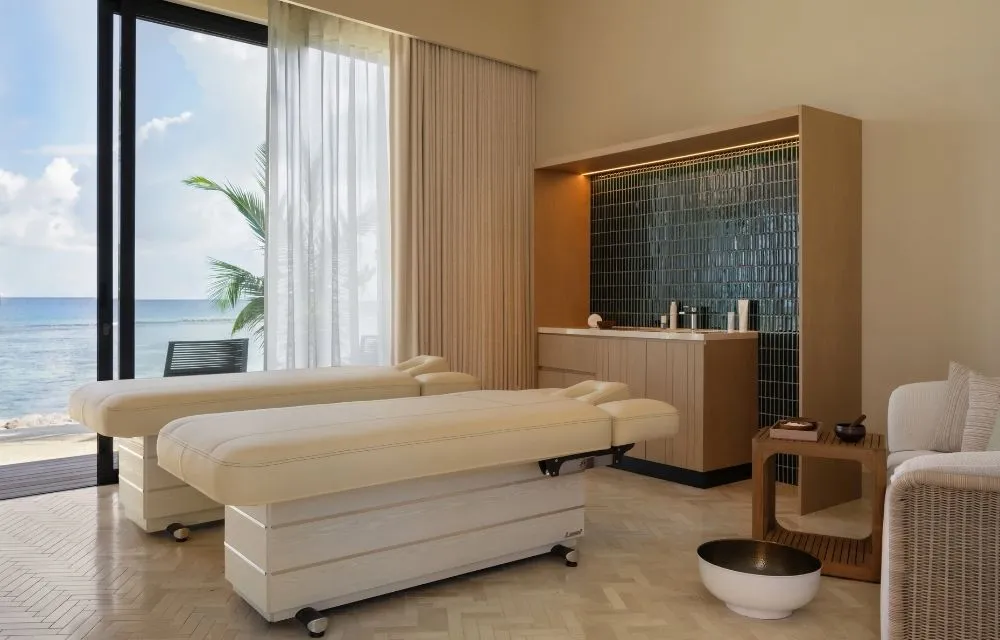 2 treatment beds beside an ocean-facing window.