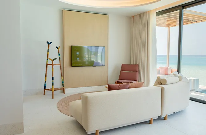 Living room with 2 sofas and large windows/deck/ocean.