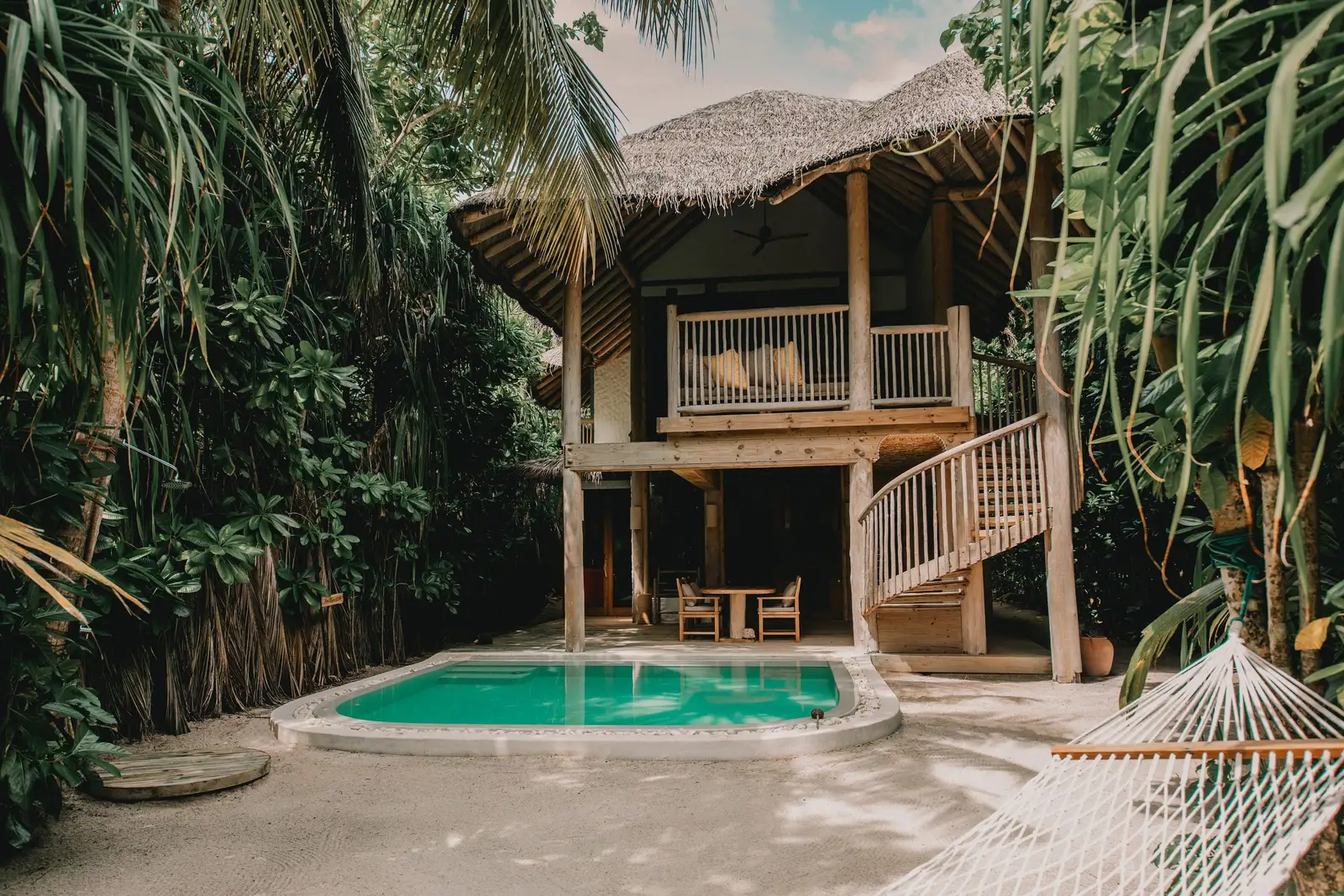 Crusoe Suite with Pool: the 2-storey house with its spiral stair, pool and hammock