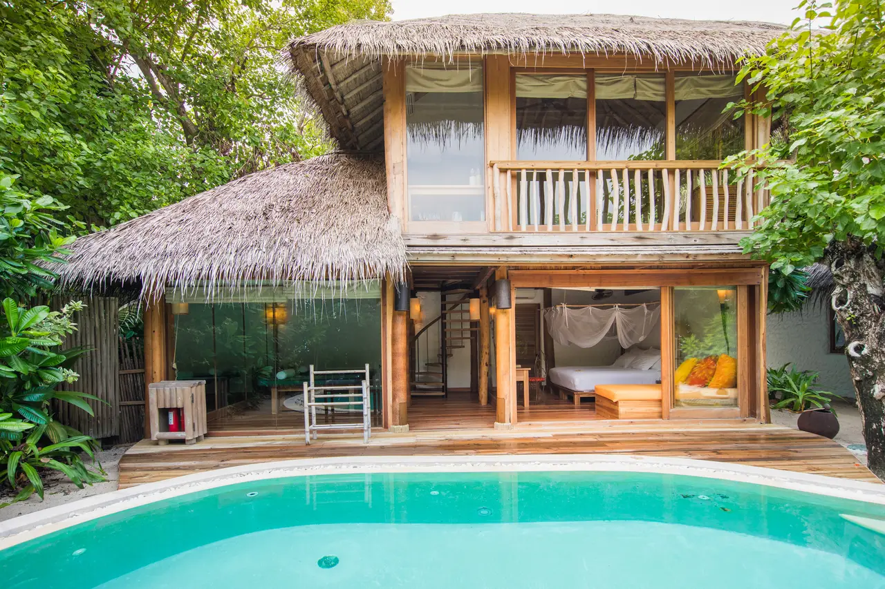 2 Bedroom Soneva Fushi Suite: the thatched 2-storey villa behind its pool